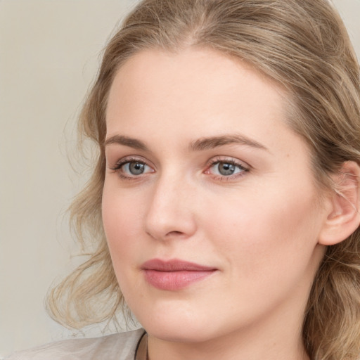 Joyful white young-adult female with long  brown hair and blue eyes