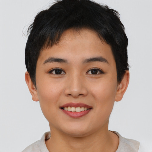 Joyful asian young-adult female with short  brown hair and brown eyes