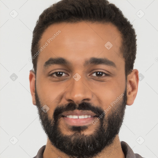 Joyful latino young-adult male with short  black hair and brown eyes