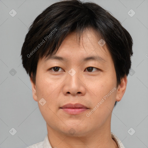 Joyful asian young-adult male with short  brown hair and brown eyes