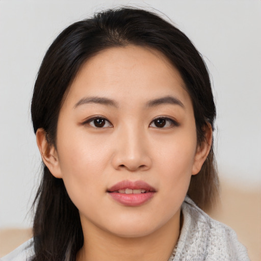 Joyful asian young-adult female with medium  black hair and brown eyes