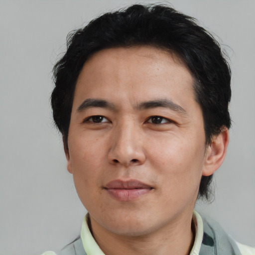 Joyful asian adult male with short  black hair and brown eyes