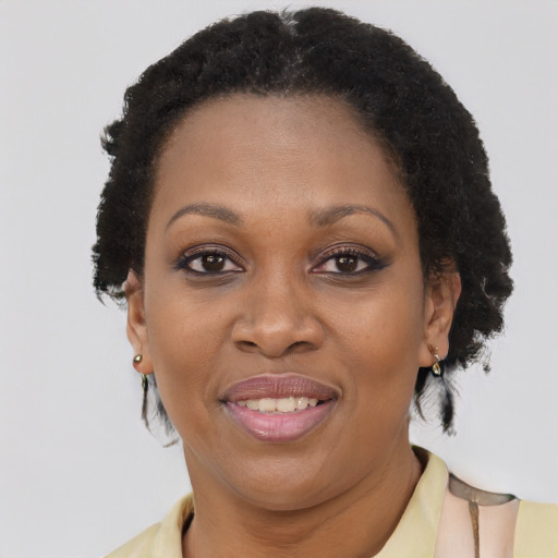 Joyful black adult female with short  brown hair and brown eyes