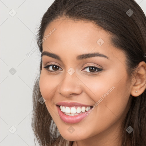 Joyful white young-adult female with long  brown hair and brown eyes