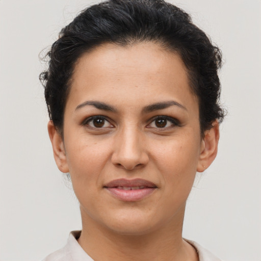 Joyful latino young-adult female with short  brown hair and brown eyes