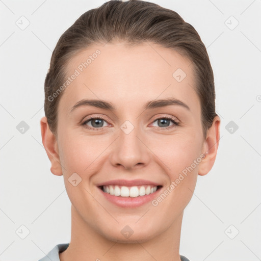 Joyful white young-adult female with short  brown hair and grey eyes