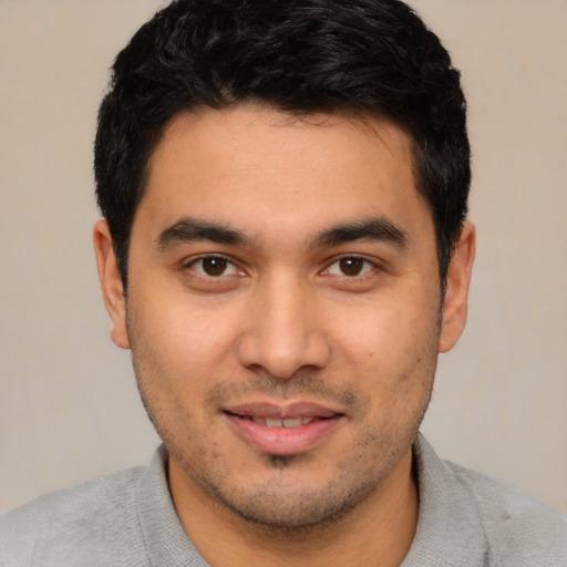 Joyful asian young-adult male with short  black hair and brown eyes