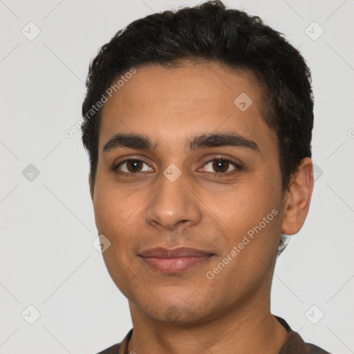 Joyful latino young-adult male with short  black hair and brown eyes