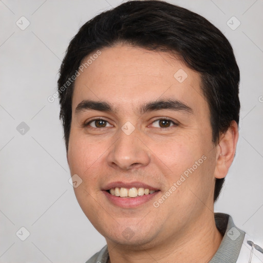 Joyful white young-adult male with short  black hair and brown eyes