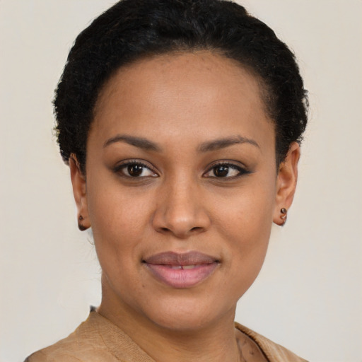 Joyful black young-adult female with short  brown hair and brown eyes