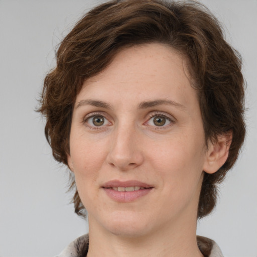 Joyful white young-adult female with medium  brown hair and green eyes