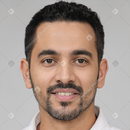 Joyful latino young-adult male with short  black hair and brown eyes