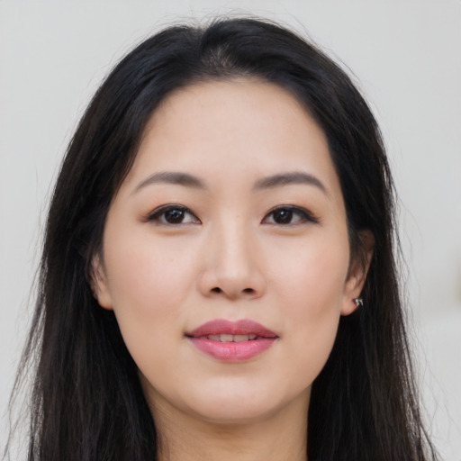 Joyful asian young-adult female with long  brown hair and brown eyes