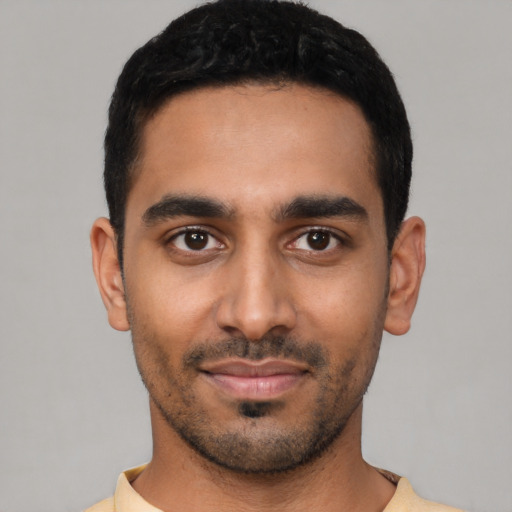 Joyful latino young-adult male with short  black hair and brown eyes