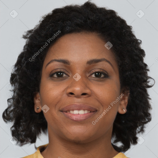 Joyful black young-adult female with long  brown hair and brown eyes