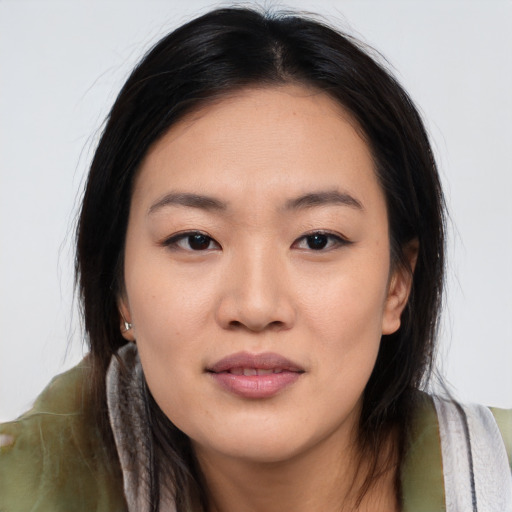 Joyful asian young-adult female with long  brown hair and brown eyes