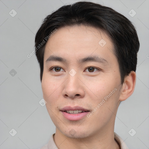 Joyful asian young-adult male with short  brown hair and brown eyes