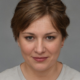 Joyful white adult female with medium  brown hair and brown eyes