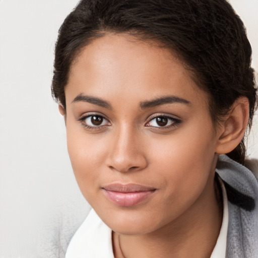 Joyful latino young-adult female with long  brown hair and brown eyes