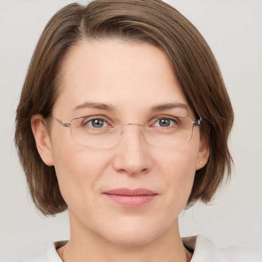 Joyful white adult female with medium  brown hair and grey eyes