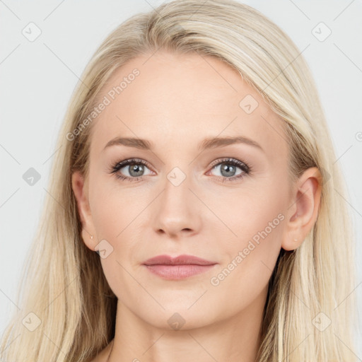 Joyful white young-adult female with long  brown hair and blue eyes