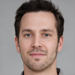 Joyful white adult male with short  brown hair and grey eyes