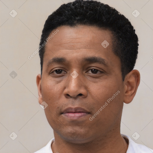 Neutral latino young-adult male with short  black hair and brown eyes