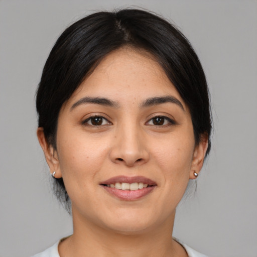 Joyful white young-adult female with medium  black hair and brown eyes