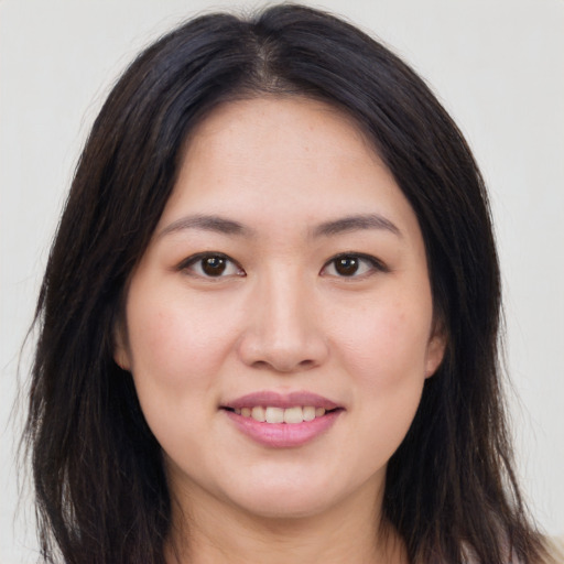 Joyful asian young-adult female with long  brown hair and brown eyes