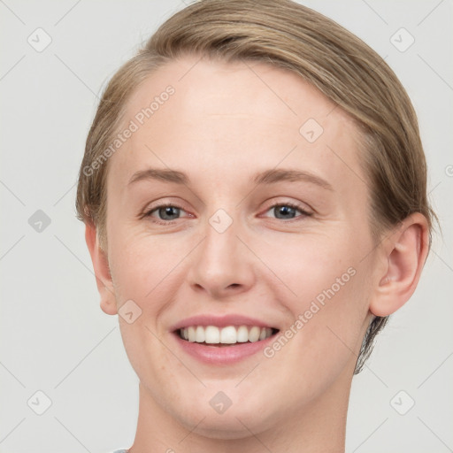 Joyful white young-adult female with short  brown hair and blue eyes