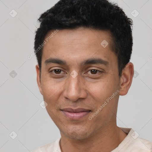 Joyful latino adult male with short  black hair and brown eyes