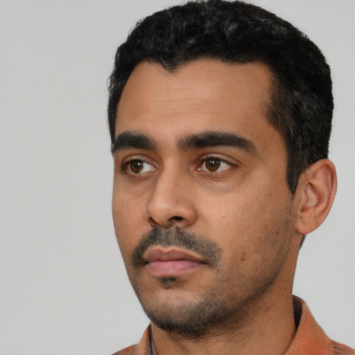 Neutral latino young-adult male with short  black hair and brown eyes