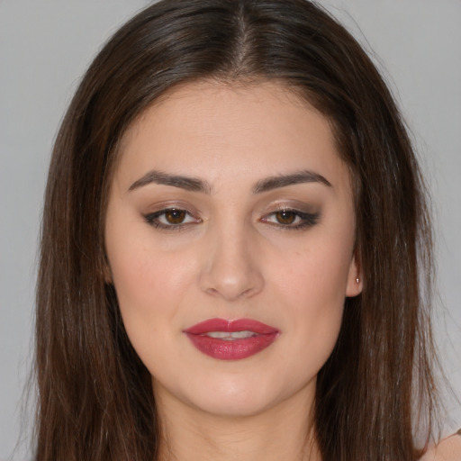 Joyful white young-adult female with long  brown hair and brown eyes