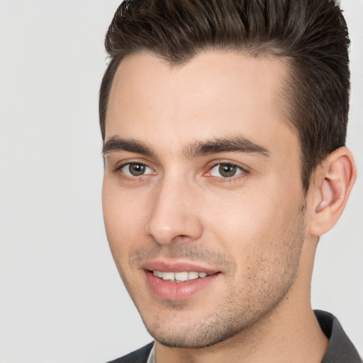 Joyful white young-adult male with short  brown hair and brown eyes