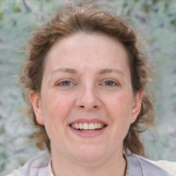 Joyful white adult female with medium  brown hair and grey eyes