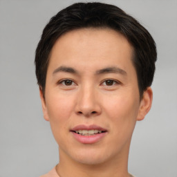 Joyful asian young-adult male with short  brown hair and brown eyes