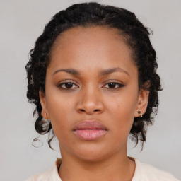 Neutral black young-adult female with medium  brown hair and brown eyes