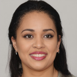 Joyful latino young-adult female with long  brown hair and brown eyes