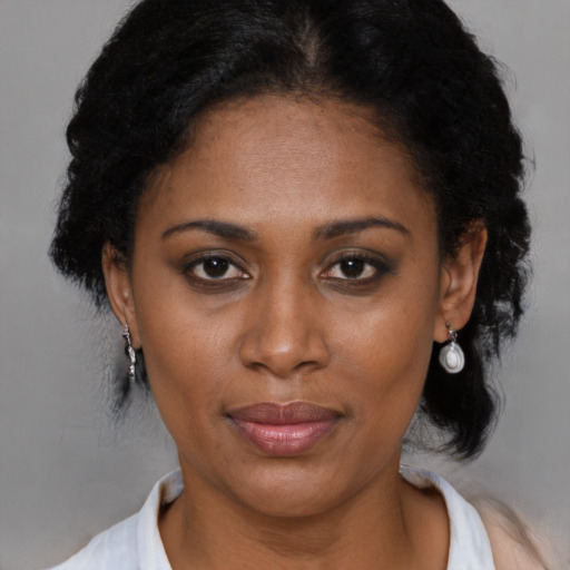 Joyful black adult female with medium  black hair and brown eyes
