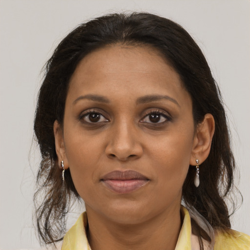 Joyful black young-adult female with medium  brown hair and brown eyes