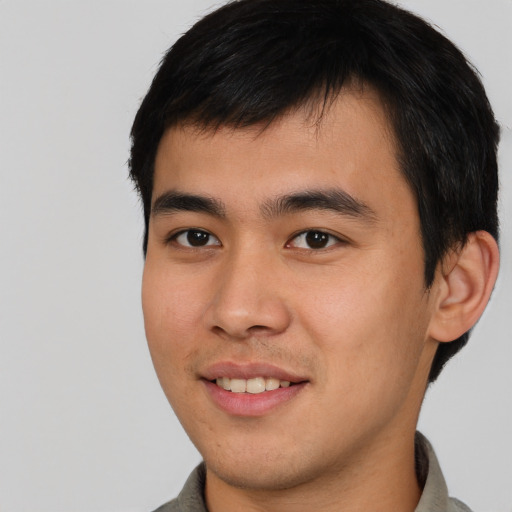 Joyful asian young-adult male with short  brown hair and brown eyes