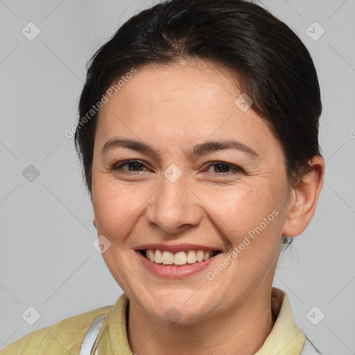 Joyful white adult female with medium  brown hair and brown eyes