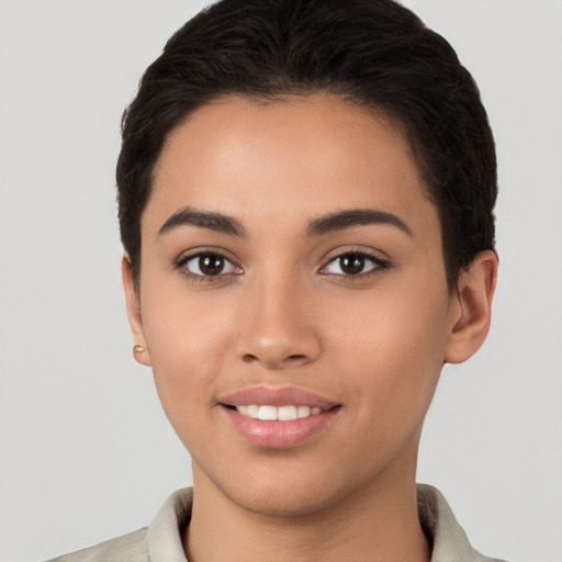 Joyful latino young-adult female with short  brown hair and brown eyes