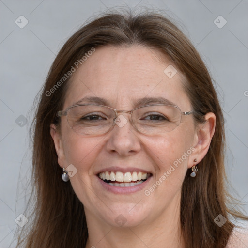 Joyful white adult female with long  brown hair and grey eyes