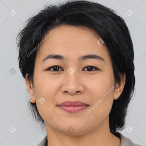 Joyful asian young-adult female with medium  black hair and brown eyes