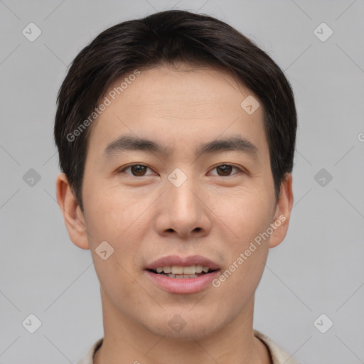 Joyful asian young-adult male with short  brown hair and brown eyes