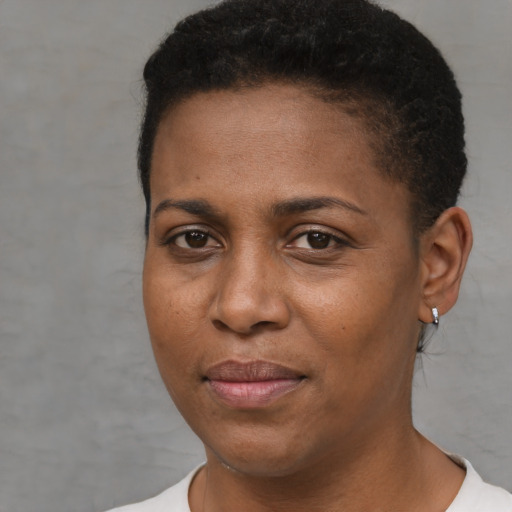 Joyful black young-adult female with short  brown hair and brown eyes