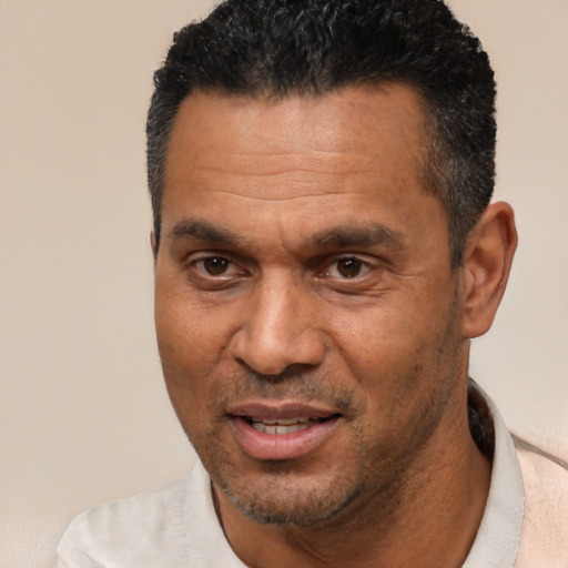 Joyful white adult male with short  black hair and brown eyes