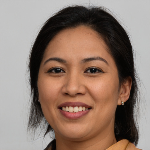 Joyful asian young-adult female with medium  brown hair and brown eyes