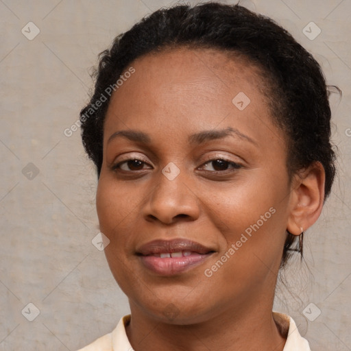 Joyful black young-adult female with short  brown hair and brown eyes